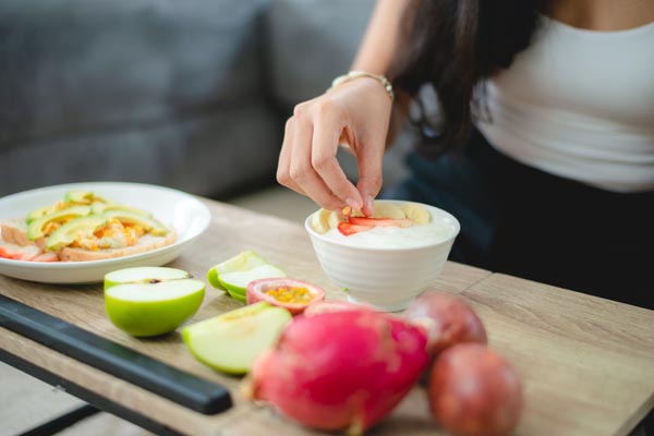 young Asian woman girl holding health food fresh vegetable in lifestyle at home